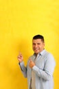 40-year-old Latino man points with the fingers at something that he likes, surprises and excites such as products and promotions Royalty Free Stock Photo