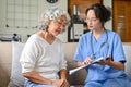 A 60-year-old elderly retire woman and her doctor having a serious talk Royalty Free Stock Photo