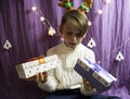 A 10-year-old European boy receives Christmas gifts, his face expresses doubt