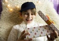 A 10-year-old European boy receives and enjoys a Christmas present