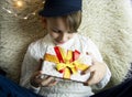 A 10-year-old European boy receives and enjoys a Christmas present