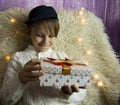 A 10-year-old European boy receives and enjoys a Christmas present