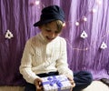 A 10-year-old European boy receives and enjoys a Christmas present