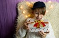 A 10-year-old European boy receives and enjoys a Christmas present