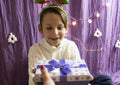 A 10-year-old European boy receives and enjoys a Christmas present