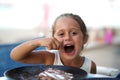 4 year old girl eating and smiling