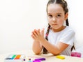 A 5-year-old girl independently sculpts figures from plasticine Royalty Free Stock Photo
