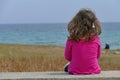 3-4 year old girl looking at the sea