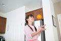 Girl with orange fruit is having fun in kitchen Royalty Free Stock Photo