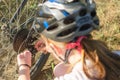 11-year-old girl repairs a bicycle in the countryside. Teenage girl repairing a bike while traveling Royalty Free Stock Photo