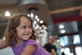 The 4-year-old girl smiles in a ferry lounge Royalty Free Stock Photo