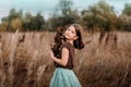 A 10-year-old girl is walking in a field. Dry grass all around. The girl is holding a bouquet. Royalty Free Stock Photo