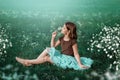 A 10-year-old girl walks in a field with white flowers. The girl is holding a bouquet. Royalty Free Stock Photo