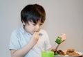 7 year old kid boy eating broccoli, chicken nuggets and roat potato for Sunday dinner, Happy child having lunch at home, Children Royalty Free Stock Photo