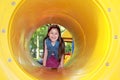 8-year-old Latin girl in the middle of a yellow tube of children`s games