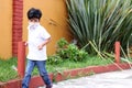 6-year-old Latino boy with covid-19 protection mouthpieces, with background vegetation Royalty Free Stock Photo