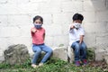 7 year old Latino boy and 5 year old girl with face masks playing