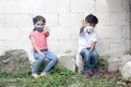 7 year old Latino boy and 5 year old girl with face masks playing