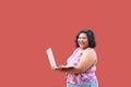 20 year old overweight brunette Latina woman uses her laptop to study, do homework, date, shop online and chat with her friends