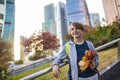 An 11 year old smiling boy with a backpack holds autumn maple red and yellow leaves in his hands. Royalty Free Stock Photo