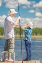 7-year-old son helps his father to fish Royalty Free Stock Photo