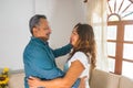 50 year old spouses dancing at home, smiling feel happy and healthy looking at each other, portrait of an old couple, concept of Royalty Free Stock Photo