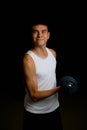 Nineteen year old teen boy exercising with a dumbbell Royalty Free Stock Photo