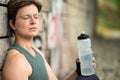 36 year old white woman drinking a bottle of water , relaxing after work out, Belgium Royalty Free Stock Photo