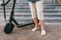 90 year old woman with gray hair, wrinkles, progressive and active uses modern electric transport scooter. Lady Royalty Free Stock Photo