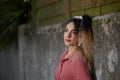 25-year-old woman with pin-up style, leaning on a stone wall Royalty Free Stock Photo