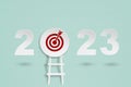 2023 with red target dartboard paper cut and ladder for setup business target concept