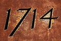 Year 1714 on rusty metallic surface Royalty Free Stock Photo