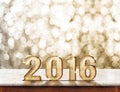 2016 year wood texture on marble table with gold sparkling bokeh wall,Holiday concept Royalty Free Stock Photo