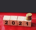 Year 2021 on wooden cubes and stack of coins. economy growth and recovery, increase money saving and investment concept Royalty Free Stock Photo