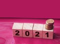 Year 2021 on wooden cubes and stack of coins. economy growth and recovery, increase money saving and investment concept Royalty Free Stock Photo