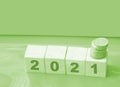 Year 2021 on wooden cubes and stack of coins. economy growth and recovery, increase money saving and investment concept Royalty Free Stock Photo