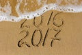 2016 and 2017 year written on beach sea.