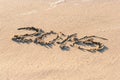 Year 2016 written in the Sand on a Beach against sunset Royalty Free Stock Photo