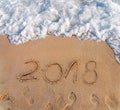 Year 2016 written in the sand on a beach New Year is coming Royalty Free Stock Photo