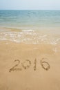 Year 2016 written in sand on beach Royalty Free Stock Photo