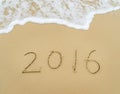 Year 2016 written in sand on beach Royalty Free Stock Photo