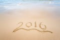 Year 2016 written in sand on beach Royalty Free Stock Photo