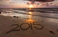 Year 2015 written on sand