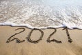 2021 year written on sandy beach sea. Royalty Free Stock Photo