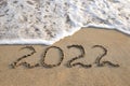 2022 year written on sandy beach sea. Royalty Free Stock Photo