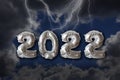 Year 2022 written with silver metallic balloon numbers with dramatic dark sky Royalty Free Stock Photo