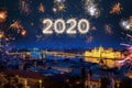 2020 year written with sparkle fireworks on night sky above Budapest