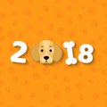 The year 2018 is a yellow earth dog. A lovely cartoon dog looks. Cartoon figures. Orange pattern from the tracks. Cover for the ca Royalty Free Stock Photo