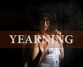 Yearing written on virtual screen. hand of young woman melancholy and sad at the window in the rain. Royalty Free Stock Photo