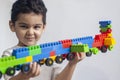 5 years adorable little kid boy playing with plastic brick toys